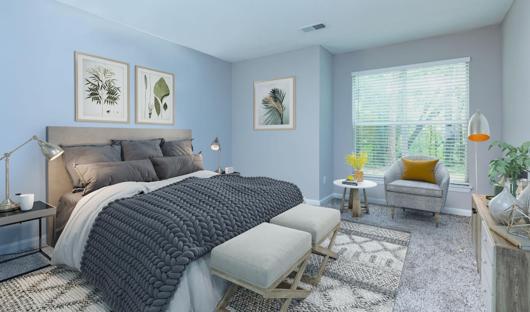 a bedroom with a bed and chairs